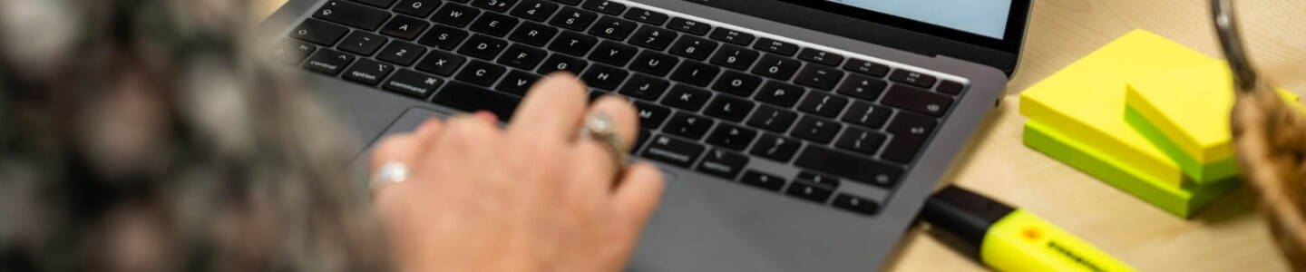 Cyber Security: laptop user with post notes and highlighter